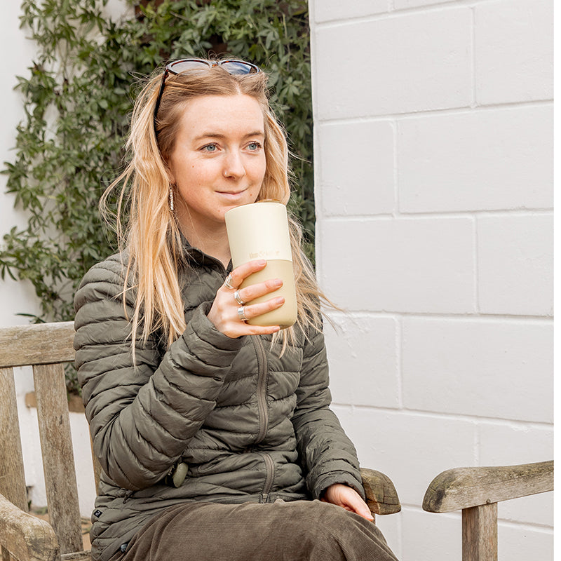 16oz-rise-tumbler-v1 16oz_rise_tumbler_wax_yellow_woman_seat_outside_square.jpg