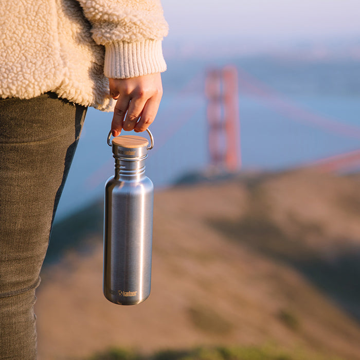27oz-reflect-with-bamboo-cap-k8 K27SSLRF-BS-BAMBOO_reflect_bottle_bridge_lifestyle.jpg